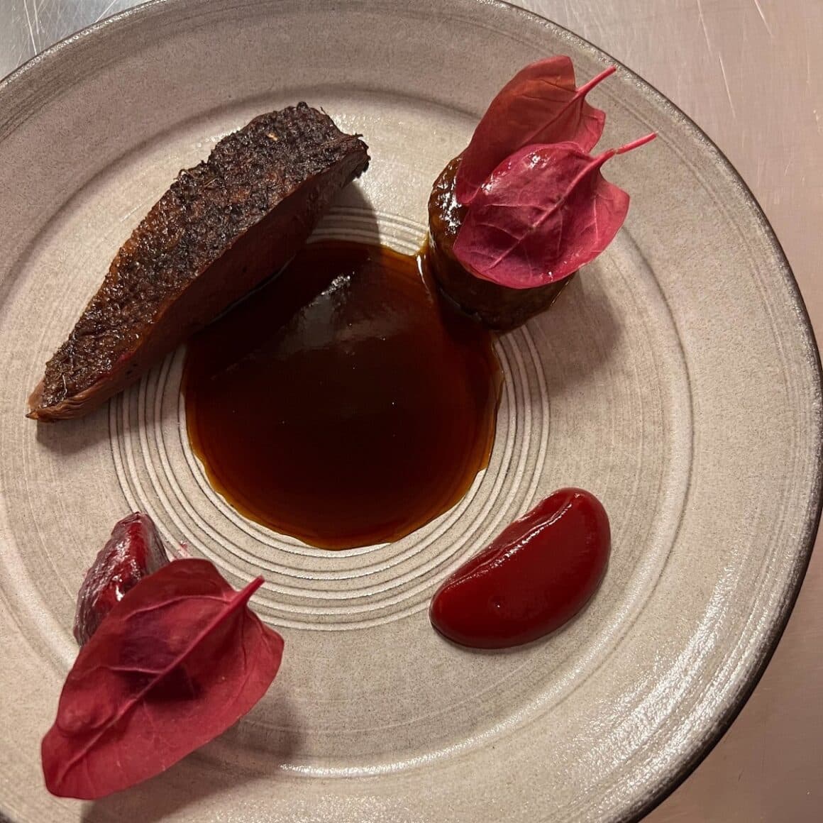 Mallard duck is slow-roasted on the bone, grilled, and then glazed it with a rosehip gastrique, La Hambar restaurant