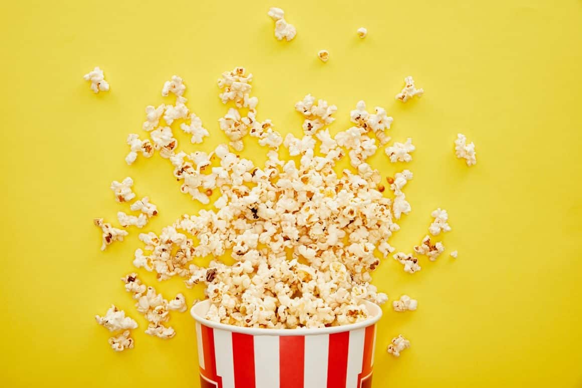 un bol cu popcorn rasturnat pe fundal galben. Despre popcorn