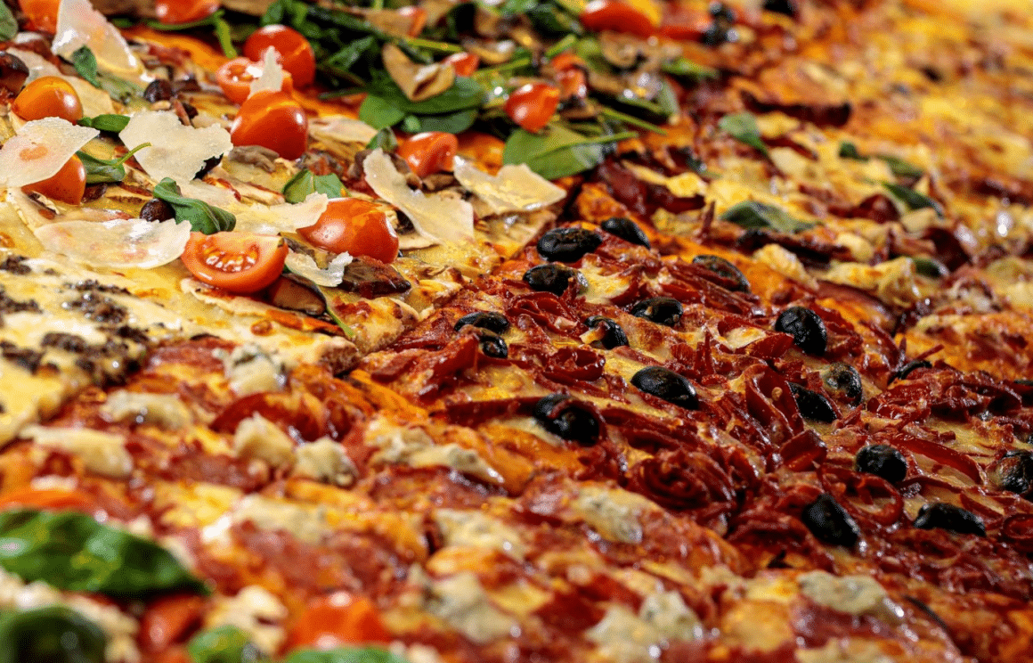 prim plan cu mai multe felii de pizza, de diverse sortimente