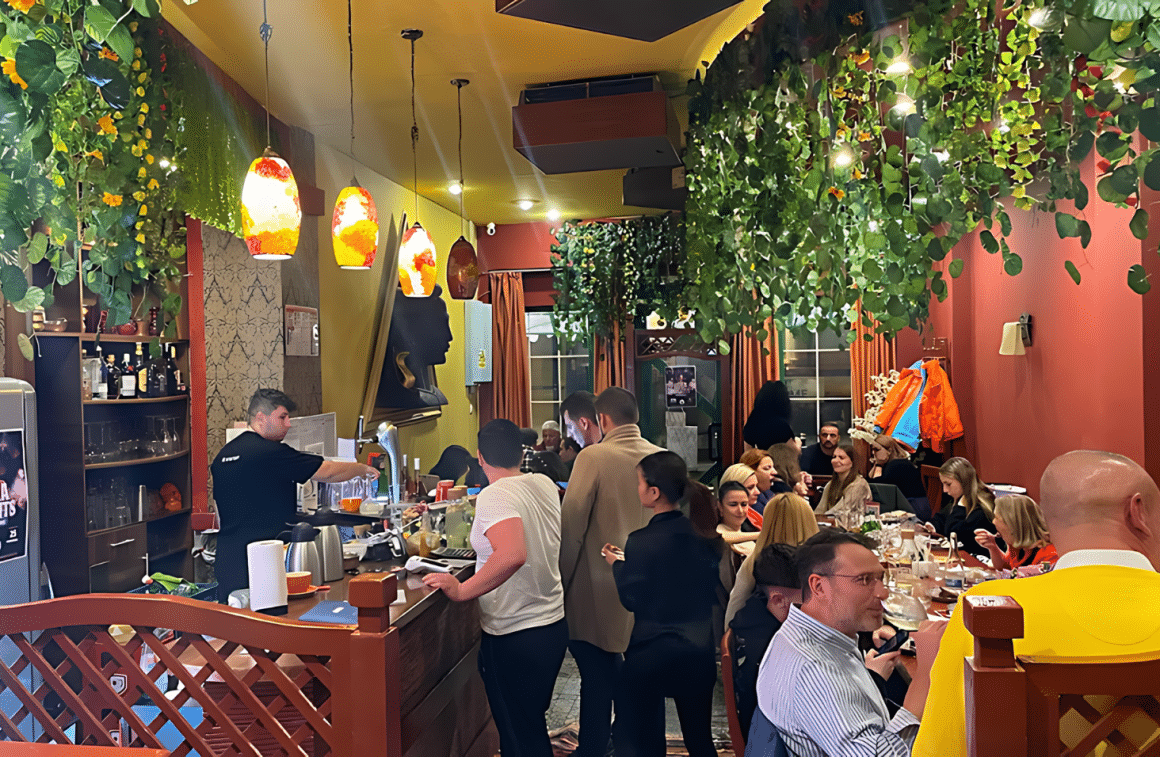 Mai multi oameni care iau masa la restaurant Isha