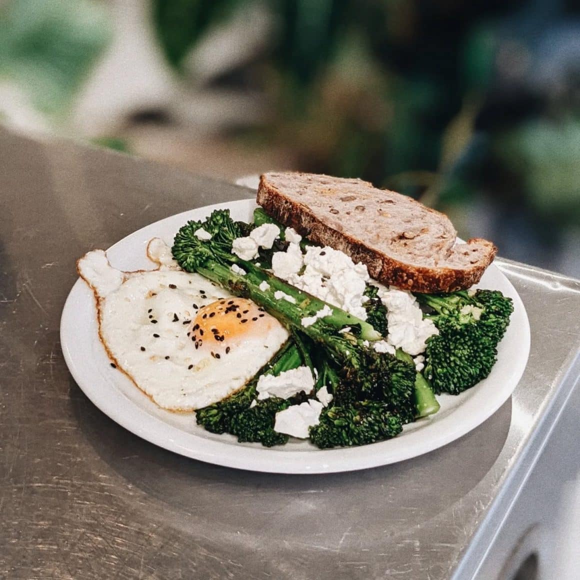 o Farfurie cu ou prajit, serviut cu branza, broccoli si paine prajita la Arzu București.  Restaurante cu mâncare sănătoasă București